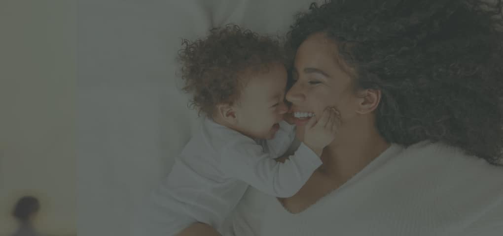 Baby and mother snuggling together